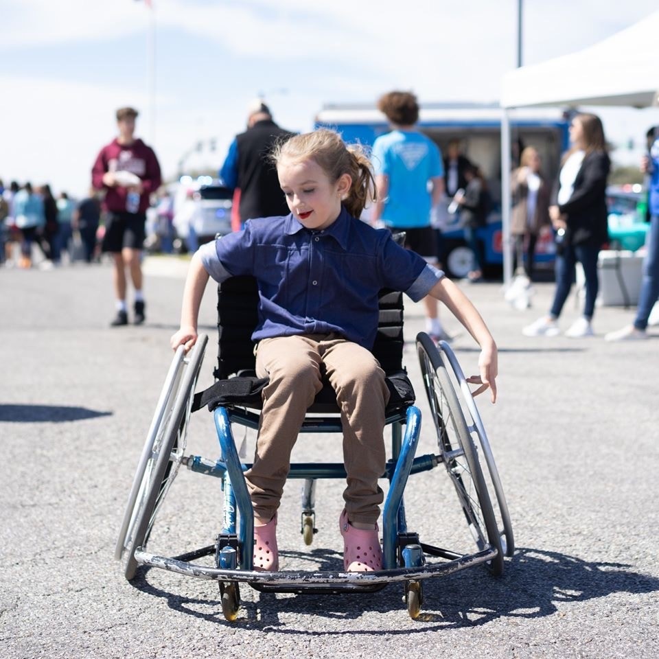 Little girl in wheelchair at beach